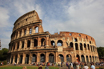 Colosseum in Rome, Italy with tourists and blue sky