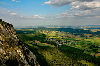 Panoramic View of Green Valley and Rocky Cliffside