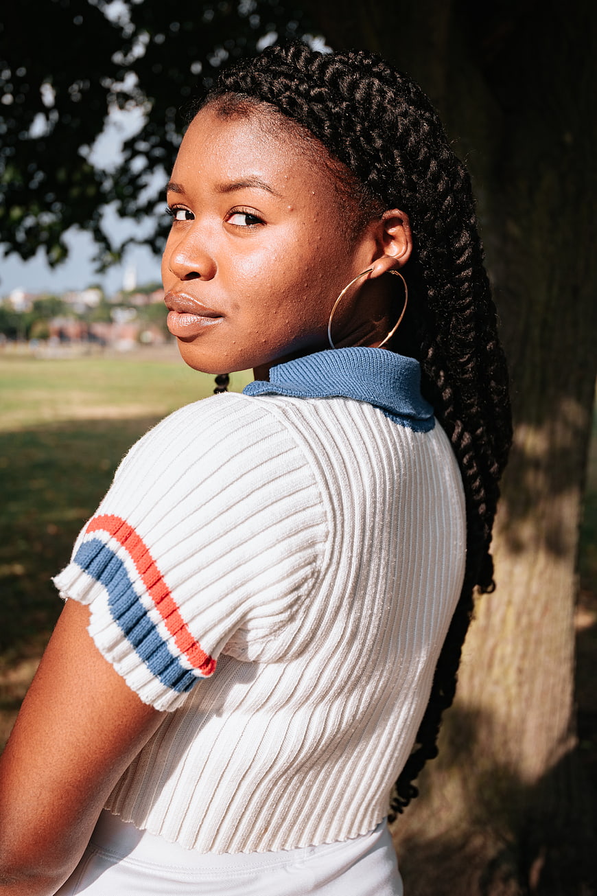 Stylish Black Woman with Braids in Park Portrait