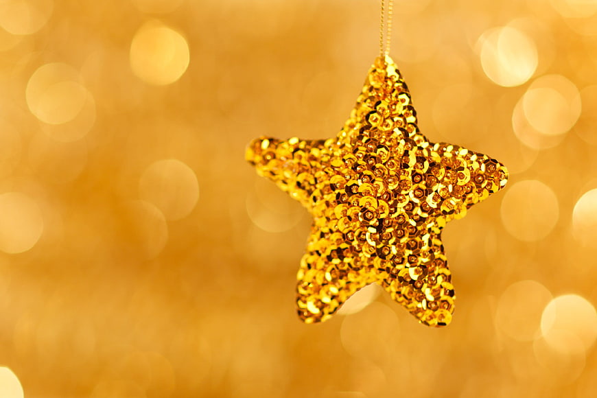 Golden Sequin Star Ornament on Bokeh Background
