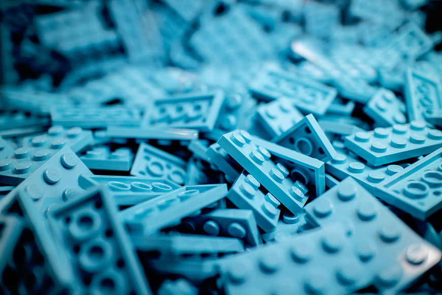 Close-up of scattered blue building blocks with shallow depth of field