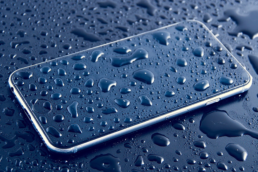 Wet Smartphone On Dark Surface With Water Droplets