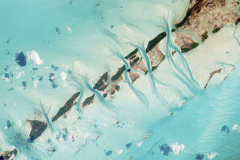 Aerial view of turquoise islands and sediment plumes in the Bahamas