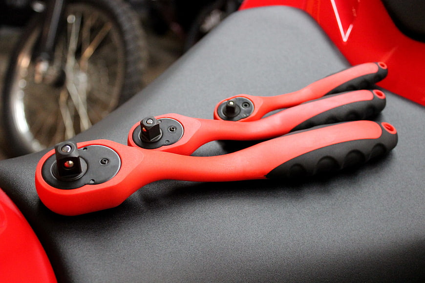 Red and Black Ratchet Wrenches on Motorcycle Seat