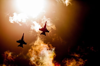 Silhouette of Two Fighter Jets Flying at Sunset