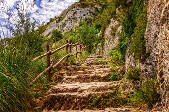 Steep stone staircase hiking trail in Mediterranean rocky landscape