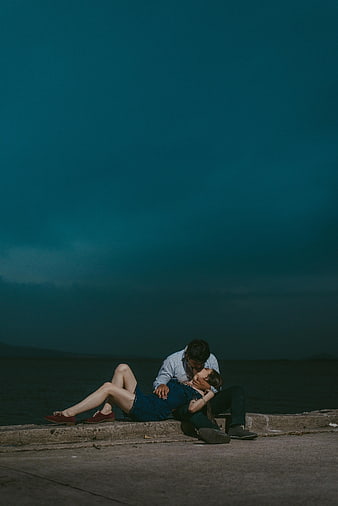 Romantic Couple Kissing by the Sea at Night
