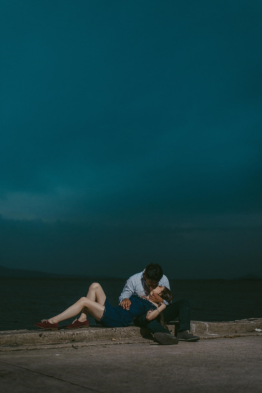 Romantic Couple Kissing by the Sea at Night