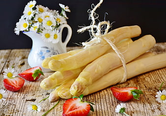 Fresh White Asparagus Bundle with Strawberries and Daisies on Rustic Wood