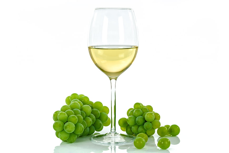 Glass of White Wine with Green Grapes on White Background