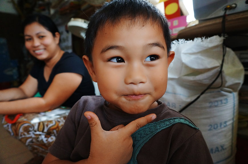 Candid Portrait of a Young Boy and Smiling Woman in a Home