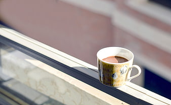 Hot chocolate mug on sunny window sill