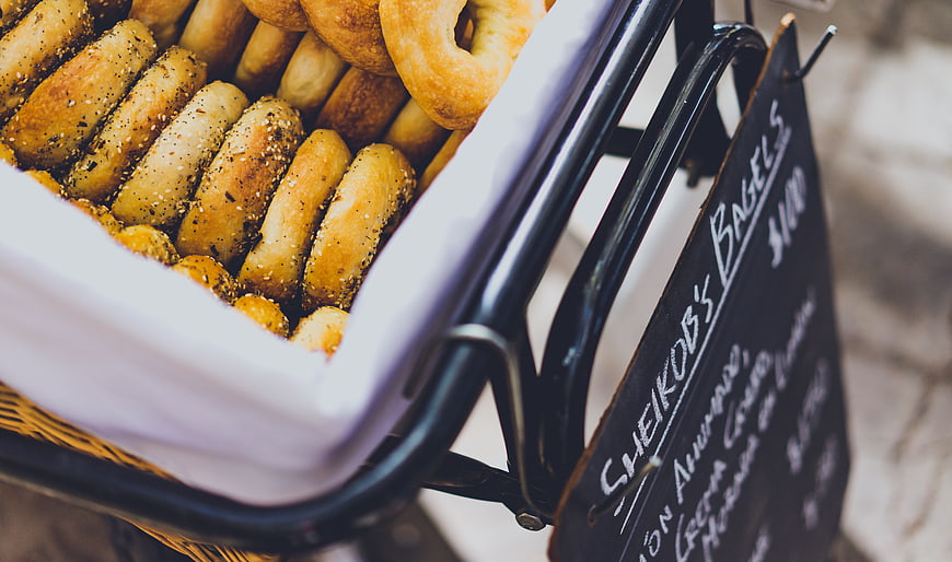 Fresh Bagels in Basket with Chalkboard Menu Sign