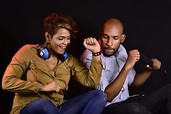 African American couple dancing and listening to music with headphones