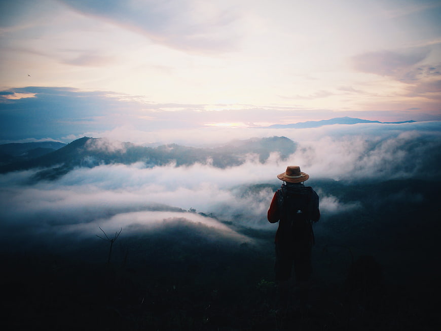 Hiker Silhouette Overlooking Sea of Clouds at Sunrise