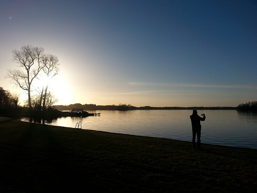 Silhouette of Photographer Taking Photo at Lake Sunset