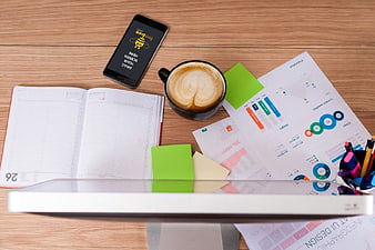 Flat lay workspace with coffee, charts, and smartphone