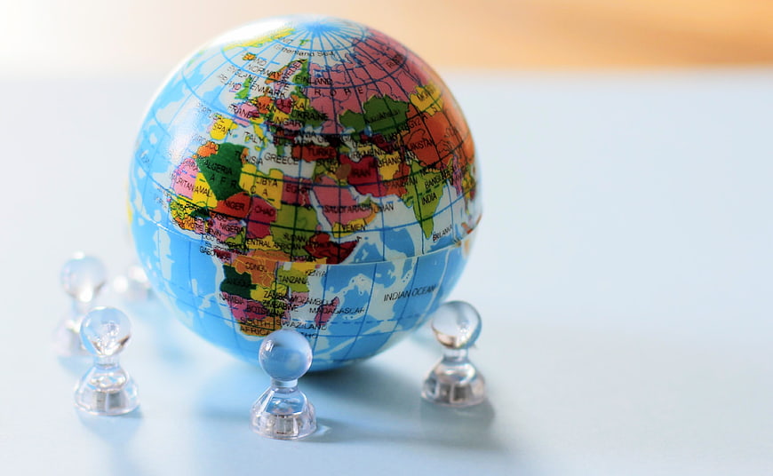 Colorful Globe with Clear Magnets on White Background