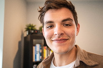 Close-up portrait of smiling young man indoors