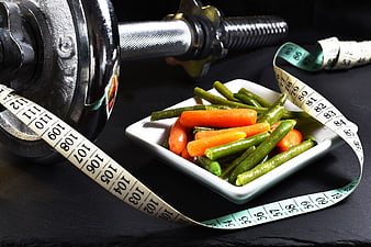 Healthy Diet and Fitness Concept with Dumbbell and Vegetables