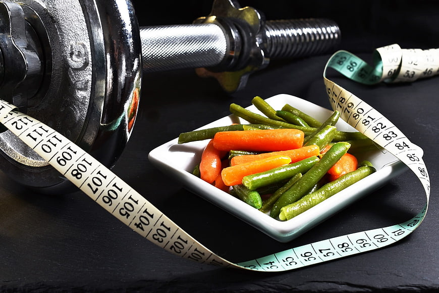 Healthy Diet and Fitness Concept with Dumbbell and Vegetables