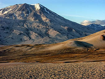 Snow-Capped Mountain Peak Overlooking Arid Valley Landscape