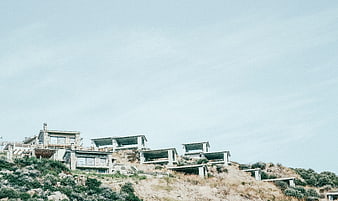 Modern concrete houses under construction on a hillside