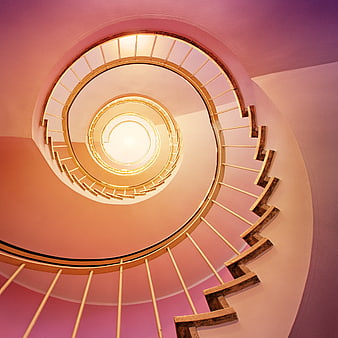 Spiral Staircase Interior With Warm Pink And Golden Lighting