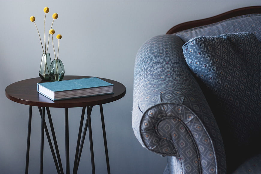 Modern Interior with Blue Sofa, Side Table, and Yellow Flowers