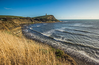 Coastal Landscape with Tower on Cliff and Blue Sky