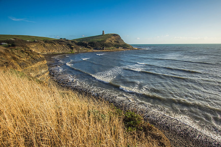 Coastal Landscape with Tower on Cliff and Blue Sky