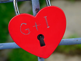 Red Heart Padlock with Initials on Metal Fence
