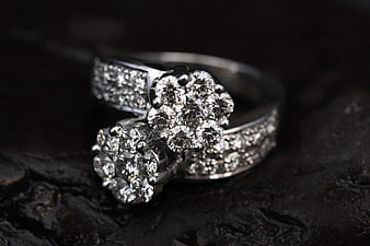 Luxury Diamond Cluster Rings on Dark Textured Surface