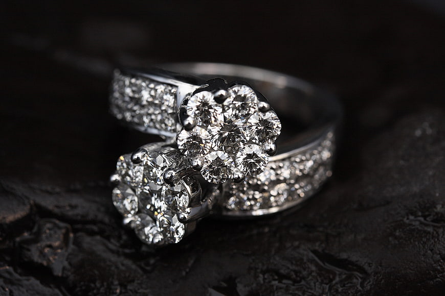 Luxury Diamond Cluster Rings on Dark Textured Surface