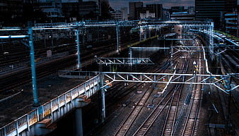 Urban Railway Tracks at Dusk with Overhead Catenary System