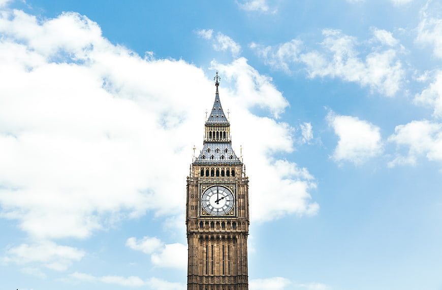Big Ben Clock Tower Against Blue Sky with Clouds