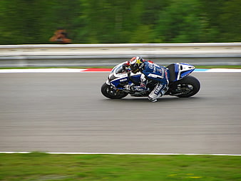Motorcyclist Racing on Track
