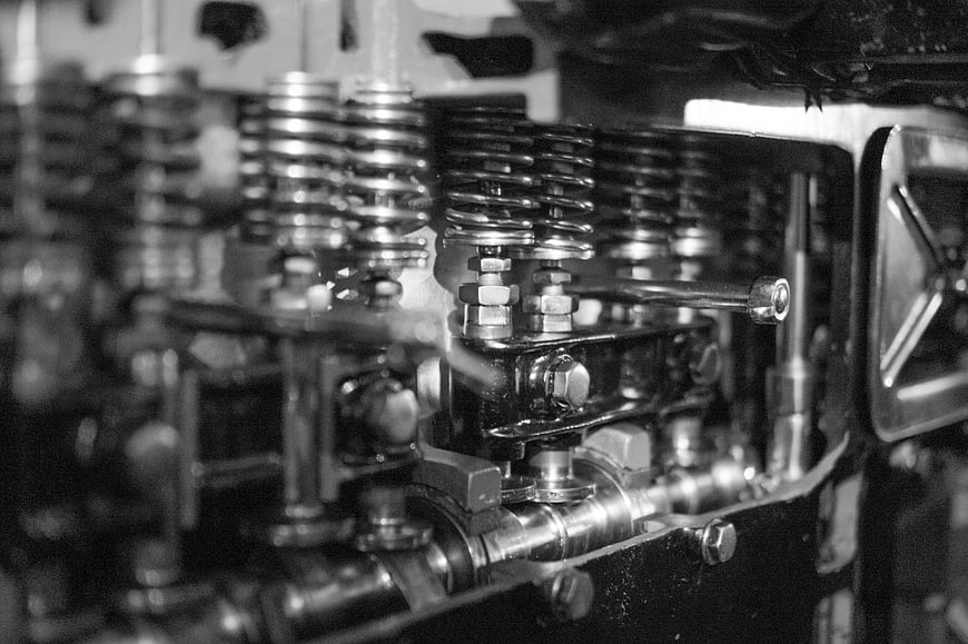 Close-up of vintage car engine valve train in black and white