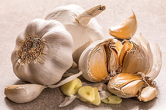 Fresh garlic bulbs and cloves on textured background