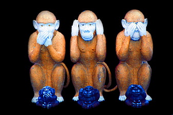 Three Wise Monkeys Wooden Statues on Black Background