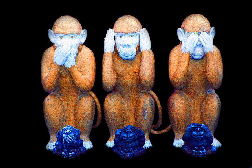 Three Wise Monkeys Wooden Statues on Black Background