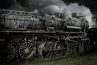 Abandoned Rusty Steam Locomotive in Overgrown Field