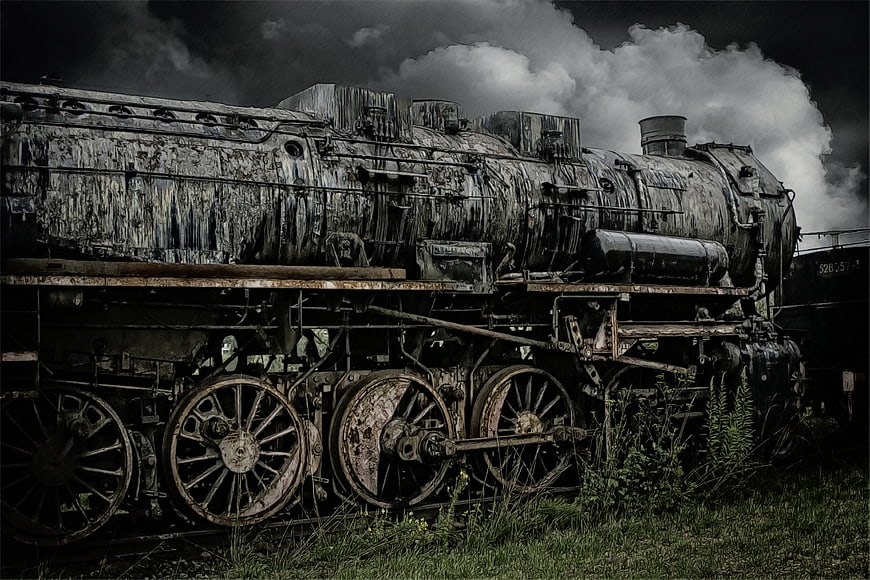 Abandoned Rusty Steam Locomotive in Overgrown Field