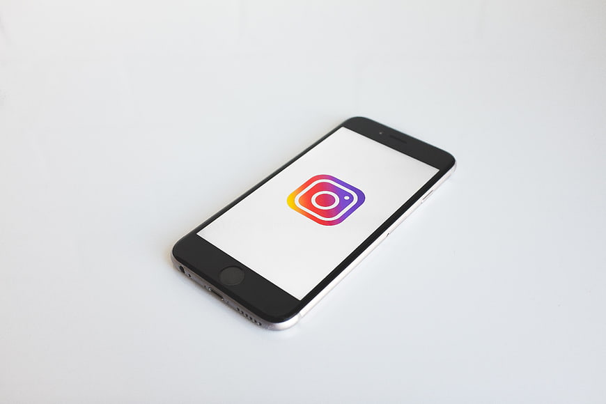Smartphone displaying Instagram logo on white background