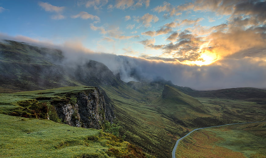 Dramatic Scottish Highland Landscape with Misty Mountains and Winding Road
