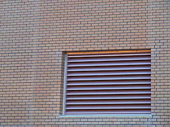 Abstract brick wall texture with horizontal ventilation louvers
