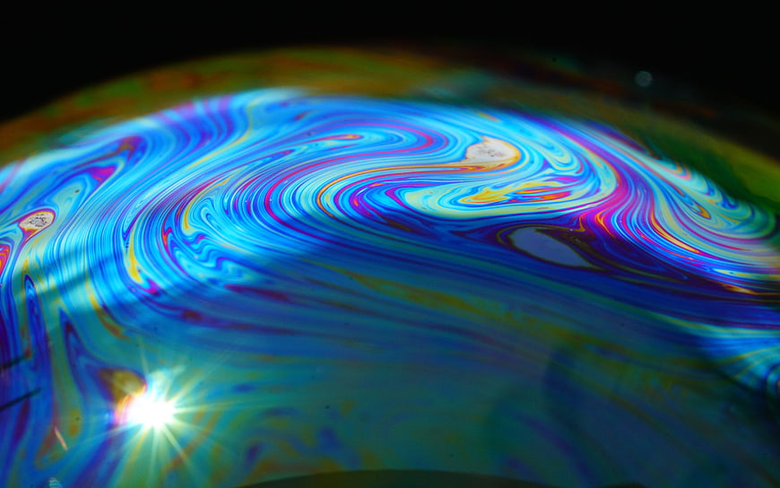Abstract macro soap bubble with vibrant rainbow interference colors