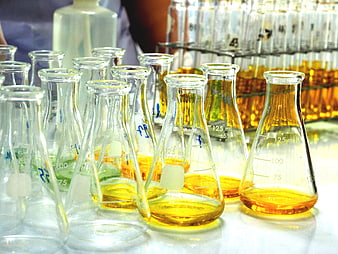 Laboratory Erlenmeyer Flasks with Yellow Chemical Liquid