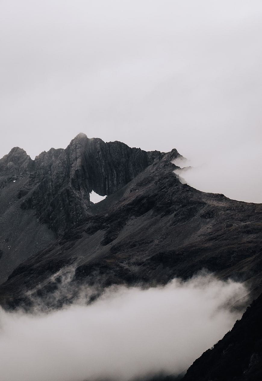 Misty Mountain Peak with Fog and Clouds