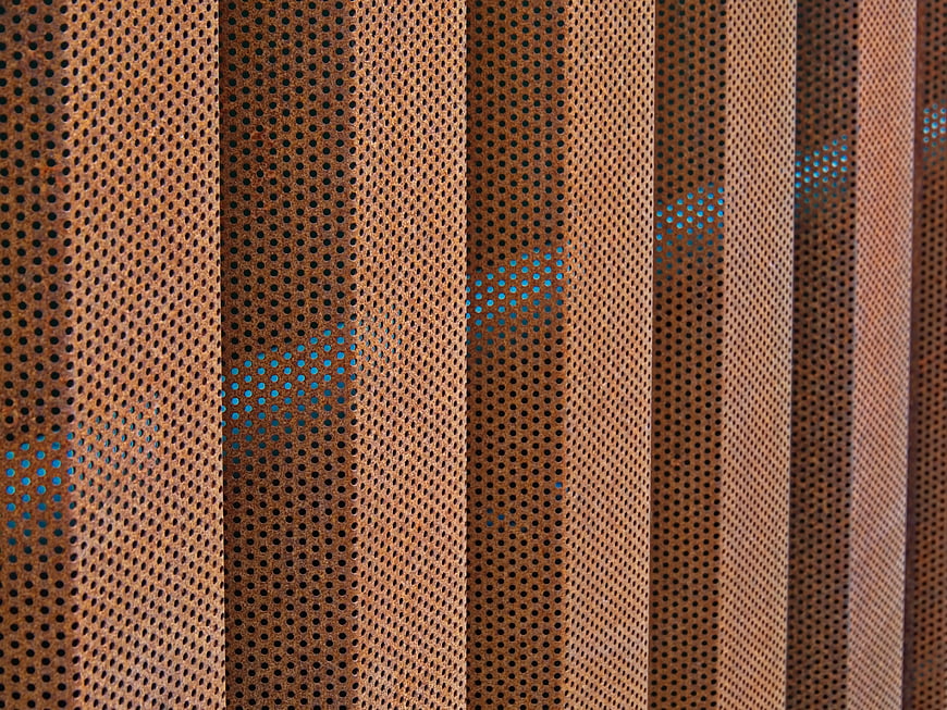 Abstract Perforated Metal Wall Texture with Blue Light